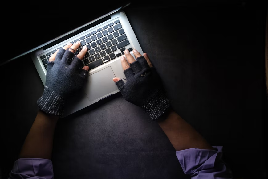 Hands typing in a computer